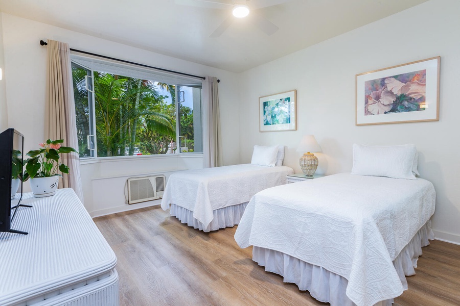 Guest bedroom has gorgeous views of the lush tropical landscape