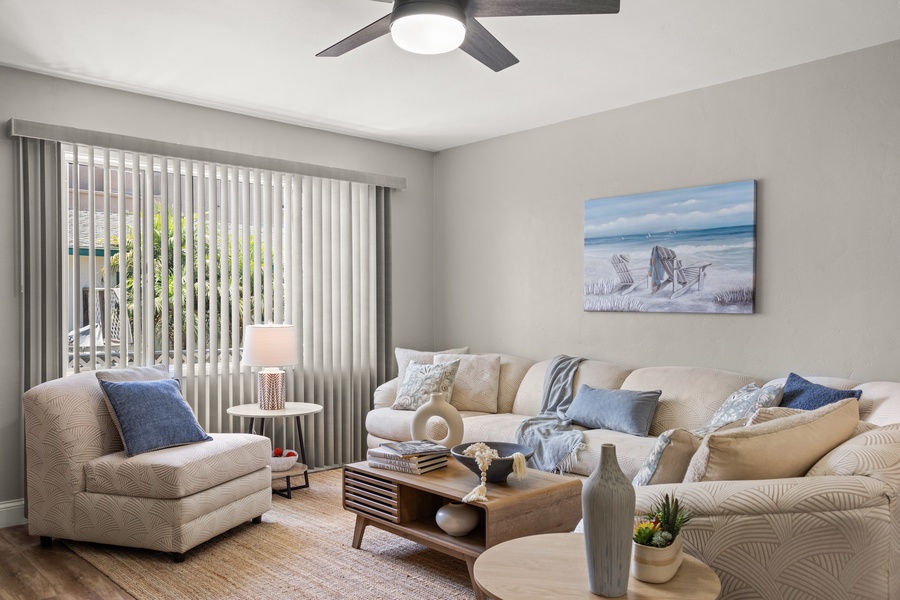 The living area features large glass windows with shades for privacy if needed.