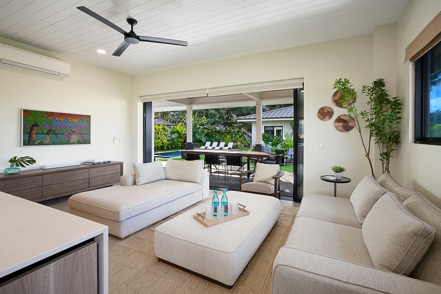 Stylish living space with natural light and lush garden views.
