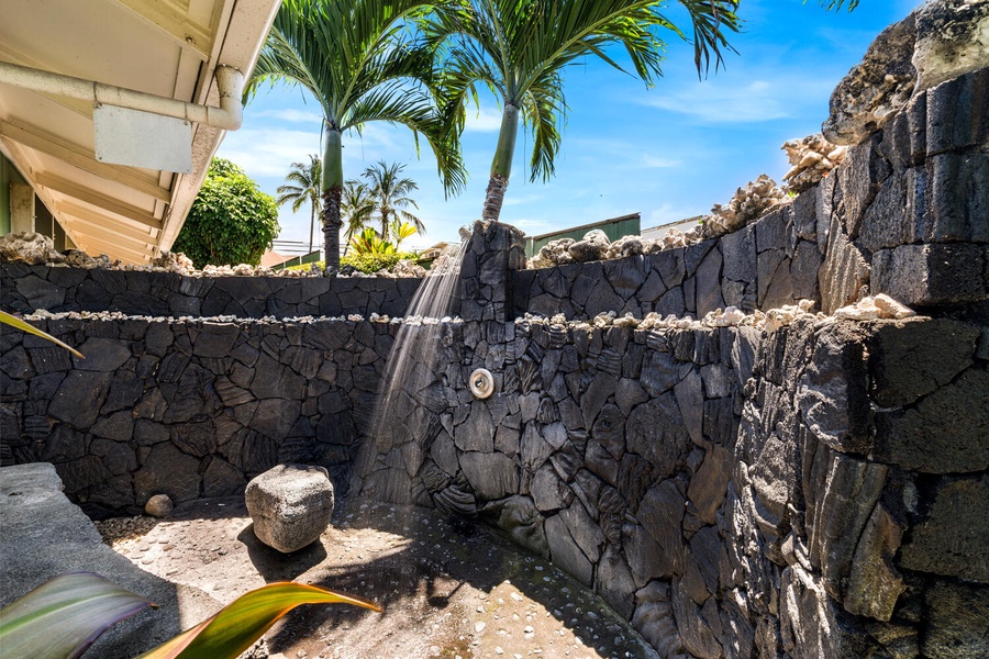 Lava-rock outdoor shower to rinse off after beach or ocean swims.