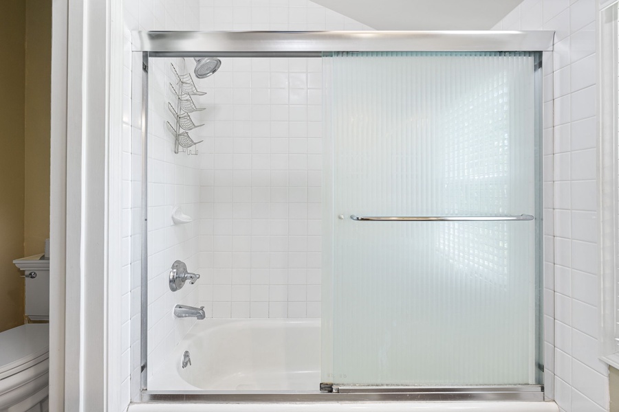 Glass-enclosed shower in the guest bathroom adds convenience and privacy.