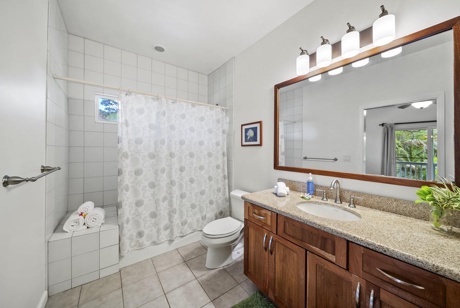 The ensuite bathroom includes a full vanity, shower/tub combo, and thoughtful amenities, making mornings easy and comfortable for every guest.