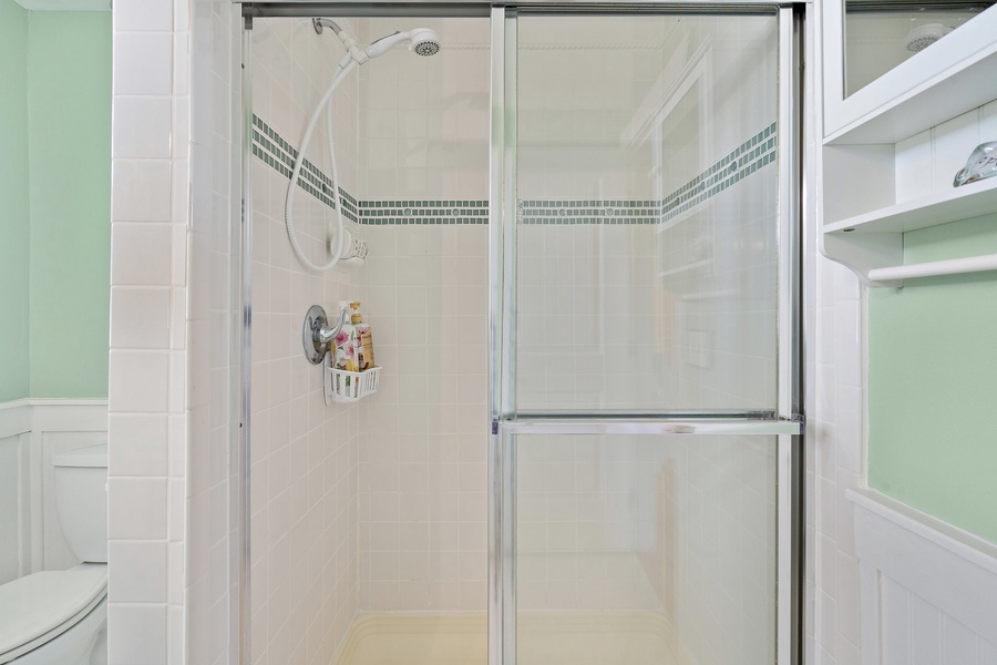 Spacious bathroom with sleek shower sliders for added privacy