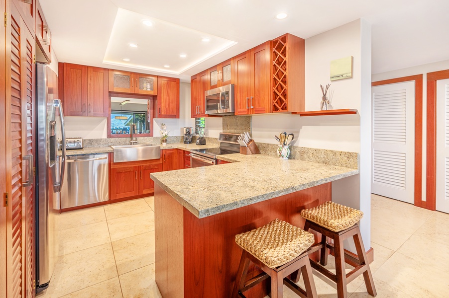 You don’t have to take your eyes off the view as you prepare meals in the full-size kitchen, where a charming breakfast bar and adjacent indoor dining table for six serve as an ideal place to gather and eat