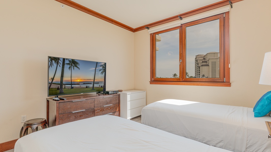 The second guest bedroom has a TV and a view.