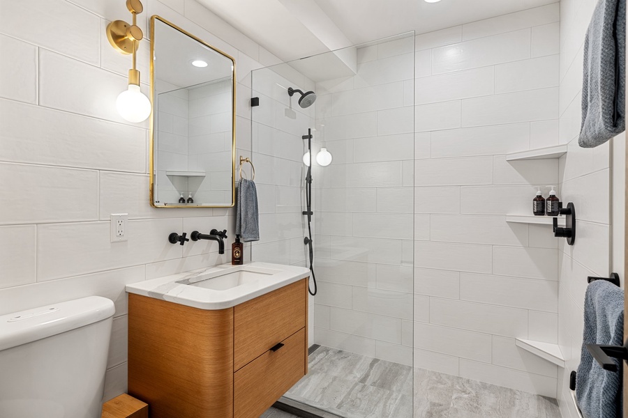 The shared bathroom with a separate walk-in shower.