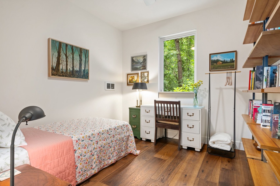 This charming twin room features bookshelf vibes and peaceful garden light.