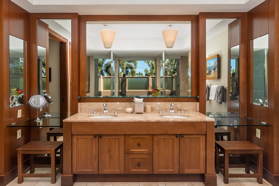 Unwind in your spa-like bathroom with dual vanities, rich wood finishes, and tropical garden views that bring serenity to your morning routine.