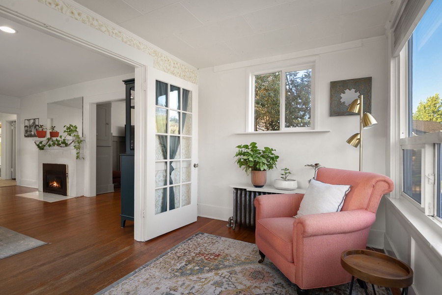 Relax with a book in this inviting sitting area featuring warm wood floors and soft light.