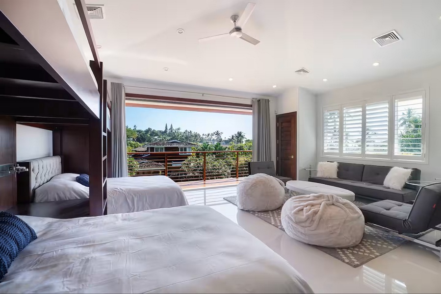 Green treetops fill the windows of this easy den above the garage.