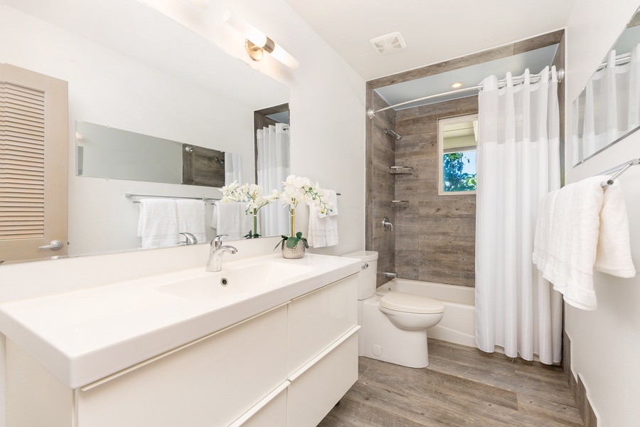 Modern guest bathroom with walk-in shower and double vanity for convenience and style.