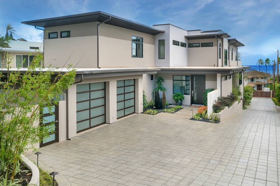 The entryway and two-car garage at Diamond Head Grandeur provide a grand welcome, ensuring both convenience and security for your luxury vacation in Honolulu.