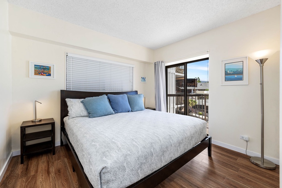 Primary bedroom with a plush king bed and private lanai access to enjoy the views.