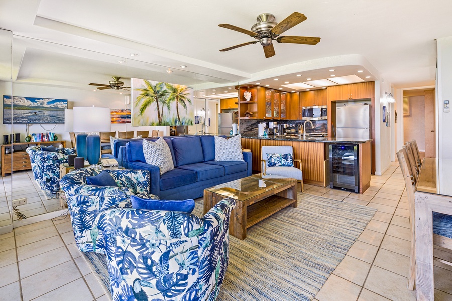 The bright and cozy living space with vibrant tropical furniture and a ceiling fan