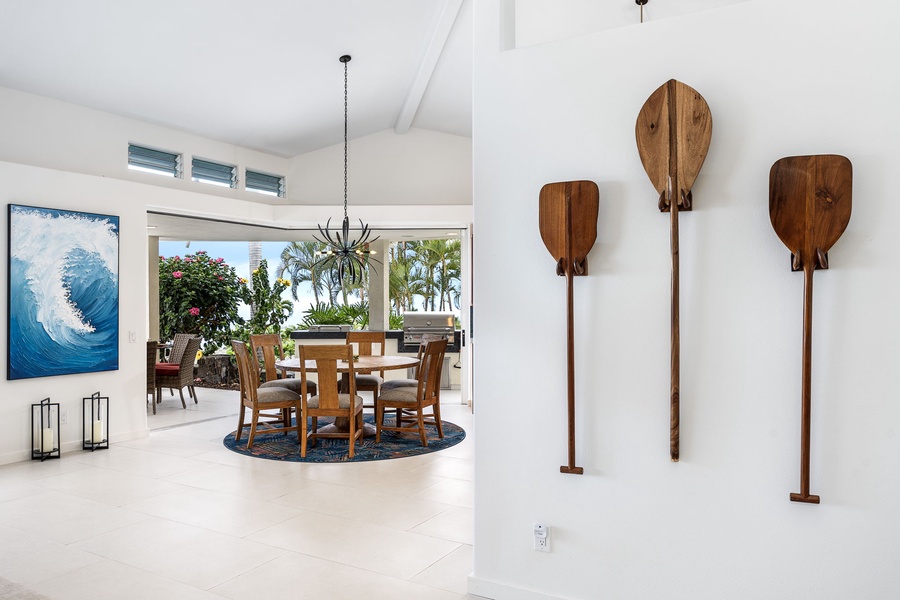 Framed by paddles and palms, this sunlit dining space sets a tropical tone, connecting guests to the spirit of Kona.