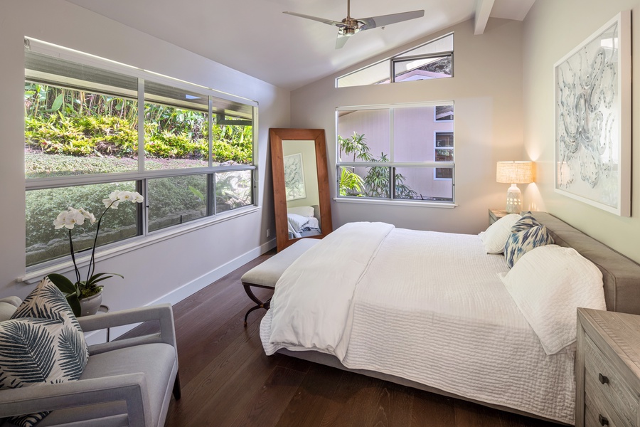 Charming guest room with Cal king bed and garden views—peaceful and airy.