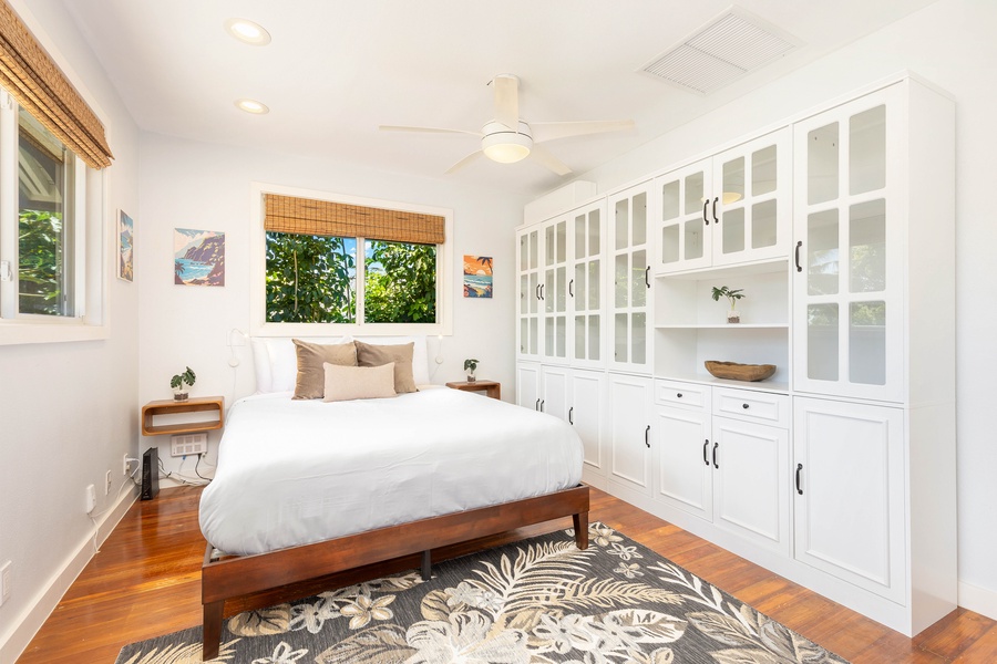 This queen bedroom includes built-in cabinetry and stylish decor, ideal for longer stays.
