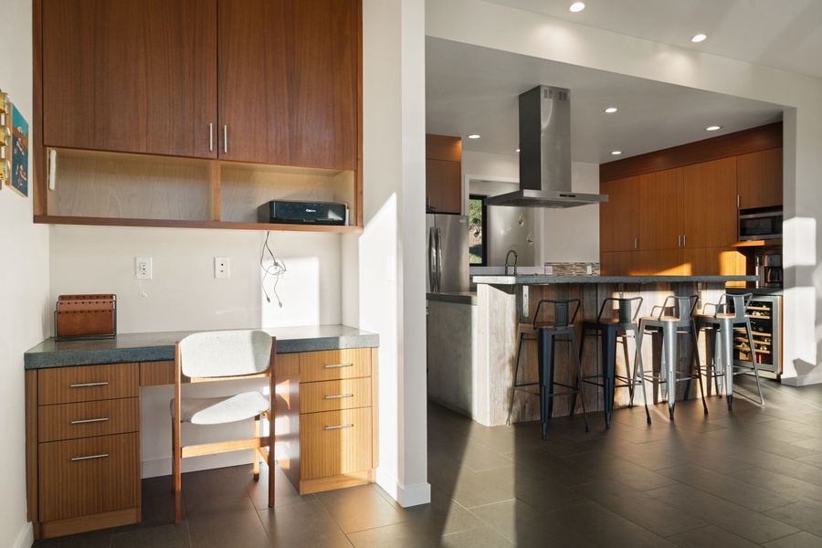 Your fully equipped kitchen flows beautifully into a dedicated workspace, creating the perfect balance for cooking and productivity during your stay.
