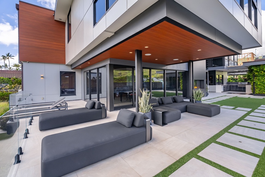 Shaded outdoor living area with comfortable seating and seamless indoor-outdoor flow.