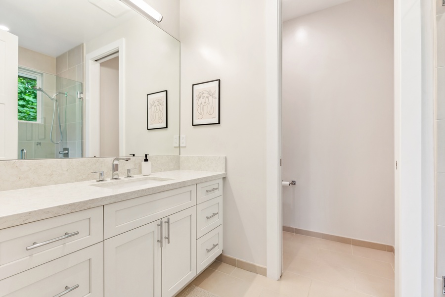 Spacious bathroom with clean finishes and modern fixtures throughout.