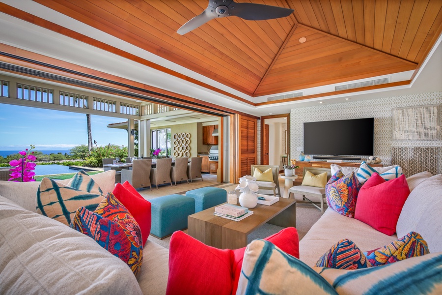 Living area with vaulted ceilings and bold beautiful fabrics and colors.