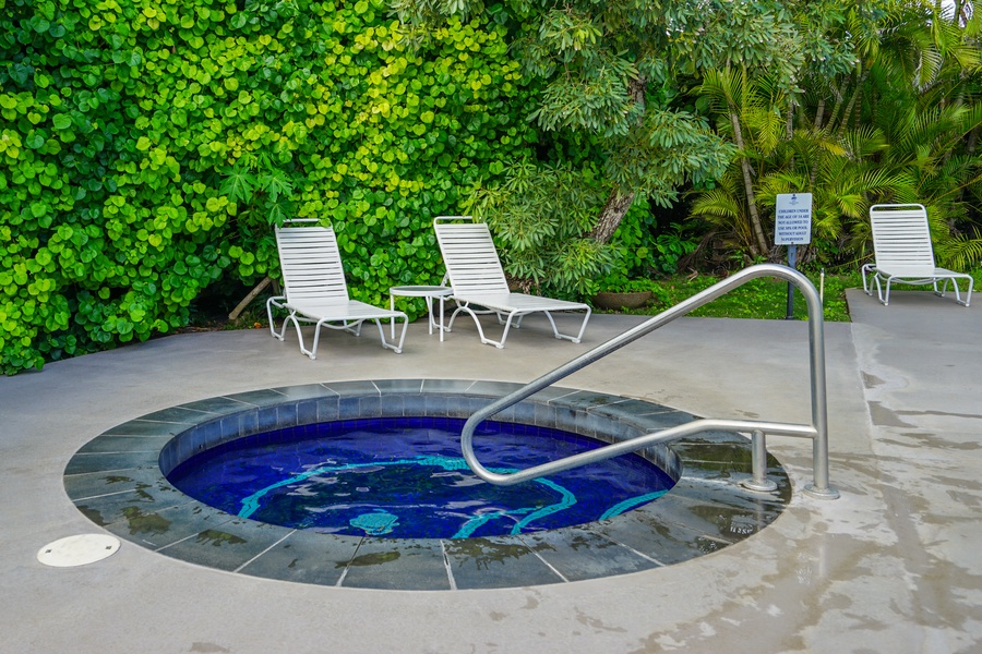 Unwind in the bubbling hot tub surrounded by lush tropical landscaping—perfect for post-adventure relaxation.