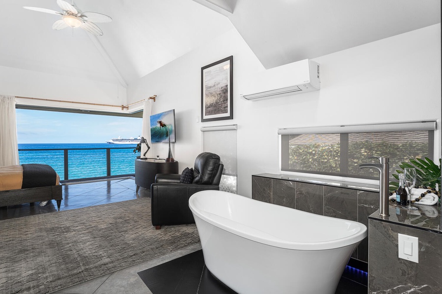 Freestanding tub with panoramic views—relax in true island style from your private ensuite.