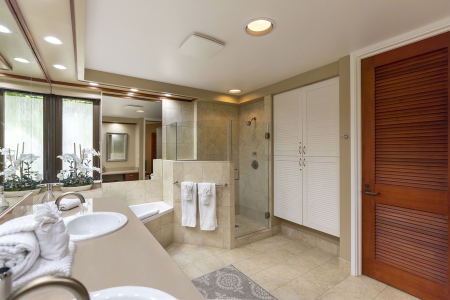 The primary bath offers a walk-in shower and double vanities.