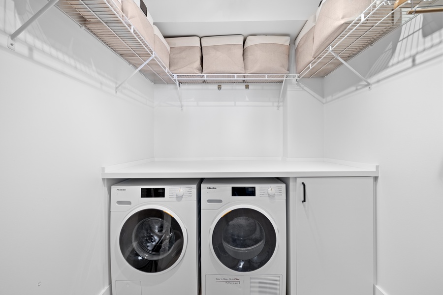 Keep your vacation wardrobe fresh with this convenient and well-equipped laundry area.