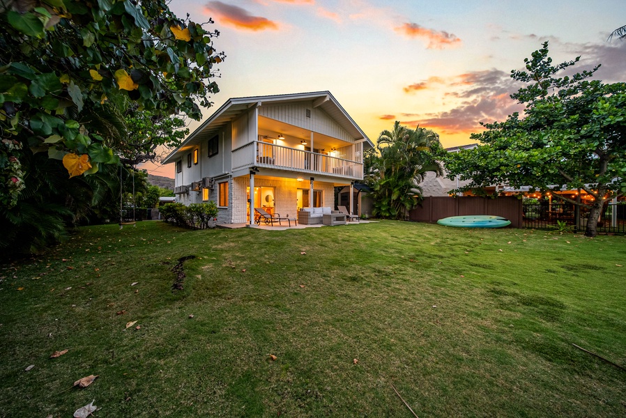 A view of the retreat at dusk, glowing from within.