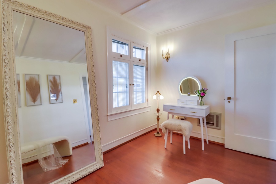 Dedicated dressing room has large mirror and two vanity areas.