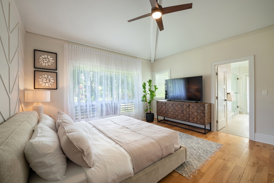 Primary bedroom with a king-size bed, neutral decor, and a spacious layout.