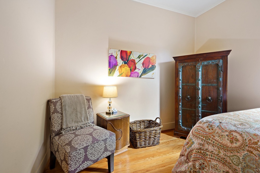 Your cozy reading nook awaits with a plush armchair and warm lamp, perfect for unwinding after exploring the city.