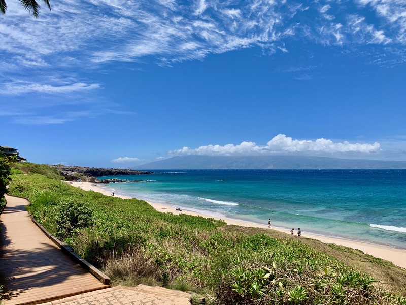 Take a leisurely stroll along the pristine beach, where soft sands meet the vibrant blue ocean