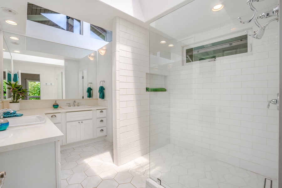 Ensuite in white finish with a walk-in shower and wide vanity space