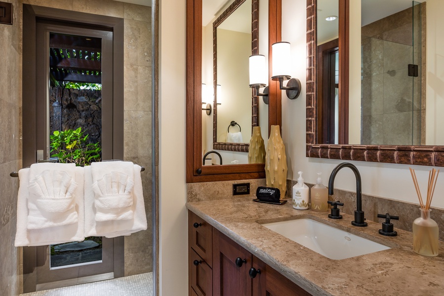 Second bedroom ensuite bathroom with granite counter tops, walk-in indoor shower and outdoor shower garden.