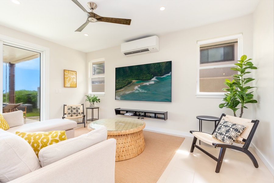 Comfortable living area with neutral tones and a wall-mounted TV for entertainment.