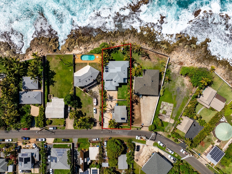 Direct overhead view reveals the two home’s full layout, backyard, and proximity to the water’s edge.