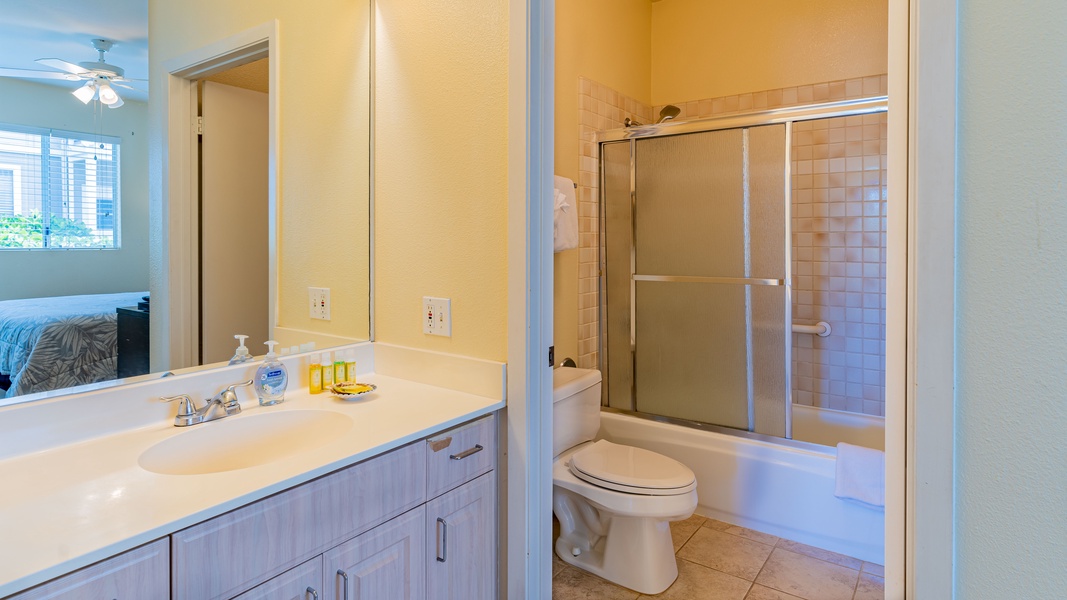The primary guest bathroom is a spacious full bathroom with ample lighting.