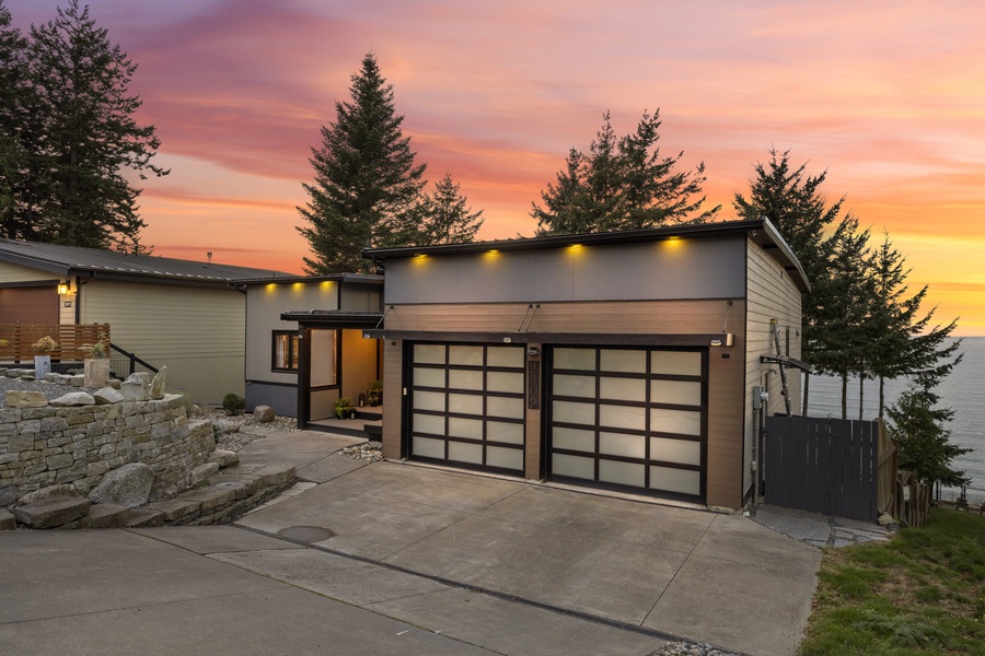 Private driveway and garage with elegant exterior lighting — a sleek and secure arrival experience.