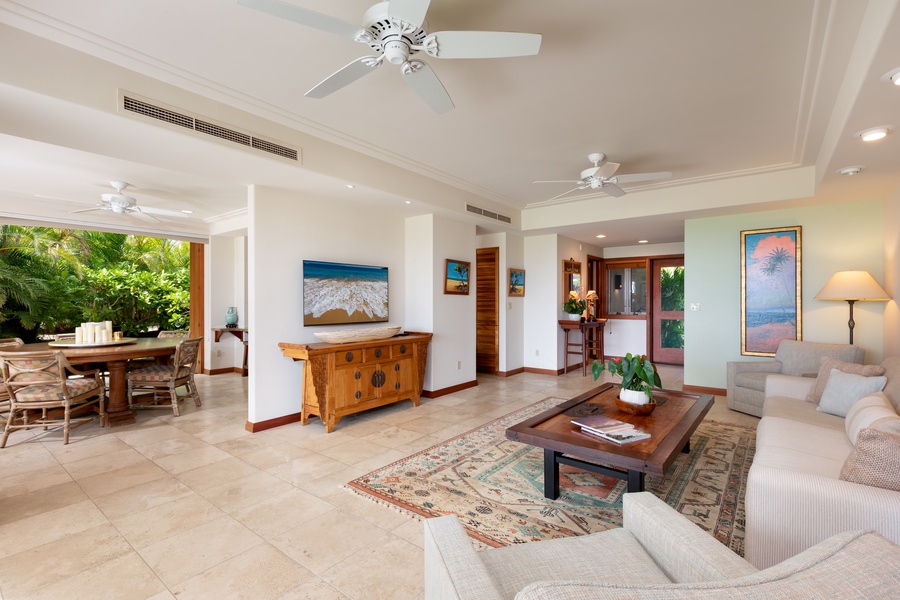 Relax in your spacious open-plan living area with tropical garden views, comfortable seating, and elegant décor.