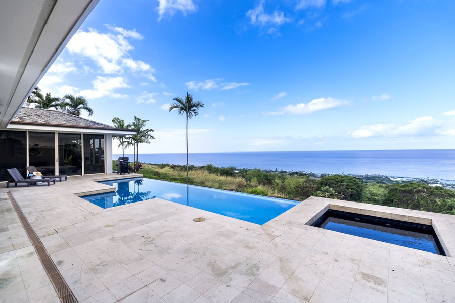 Your private pool deck offers breathtaking ocean views framed by swaying palms and endless blue skies.
