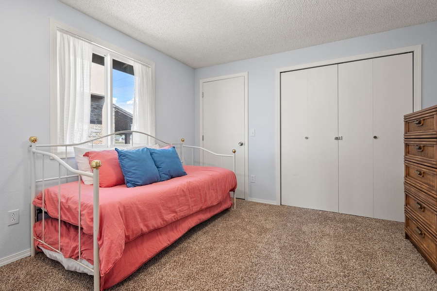 The guest room has plenty of storage and natural lighting.