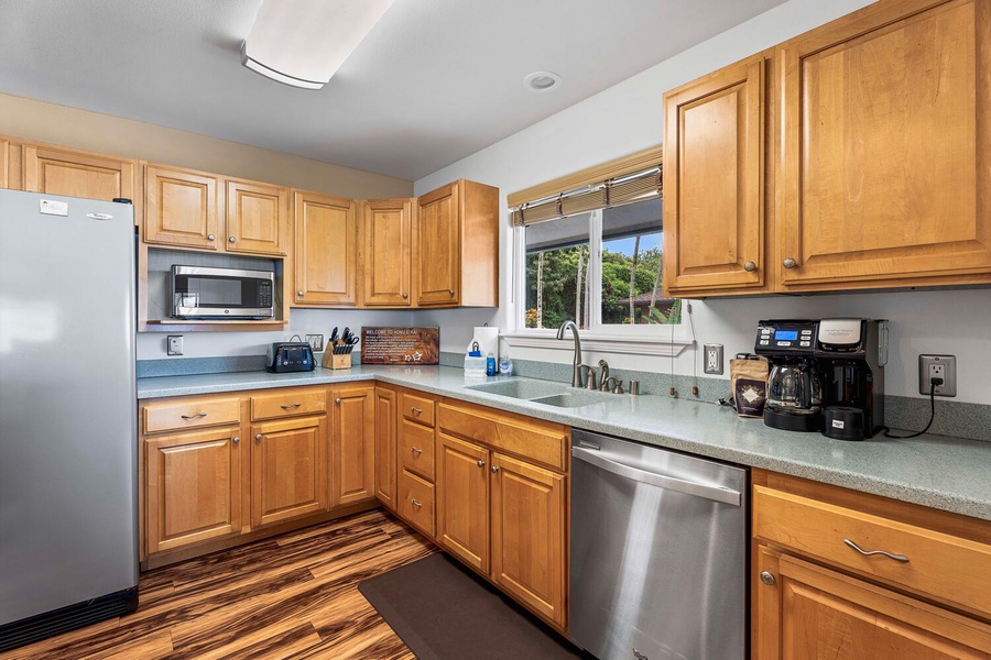 The kitchen offers wide counter spaces and plenty of cabinets for storage.