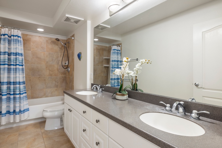 The primary ensuite bath features dual vanities and a shower/tub combo—convenient and comfortable for extended resort living.