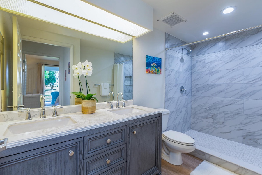 Primary ensuite with dual vanity and walk-in shower