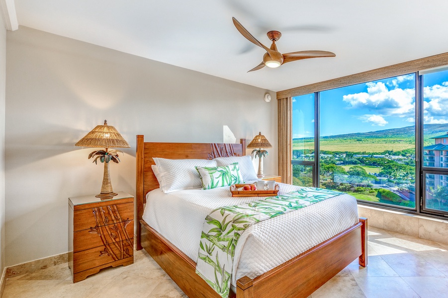 Relax in the serene secondary bedroom at Mahana 1119 and wake to lush tropical garden views.