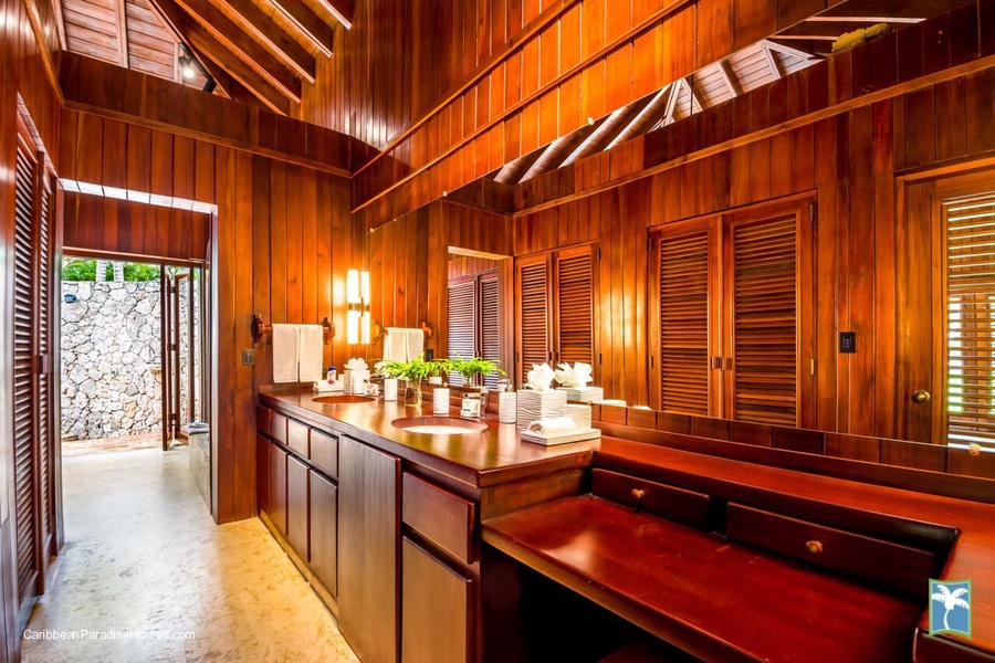 Luxurious full ensuite bathroom with wooden accents and ample lighting.