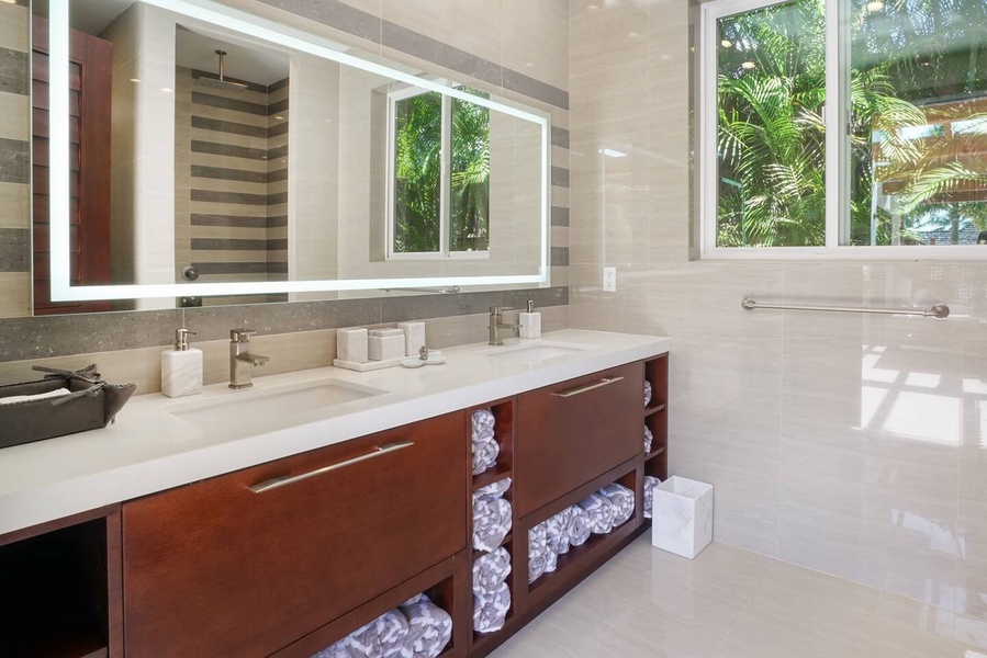 Fresh orchids and a garden window bring the green indoors at the vanity.