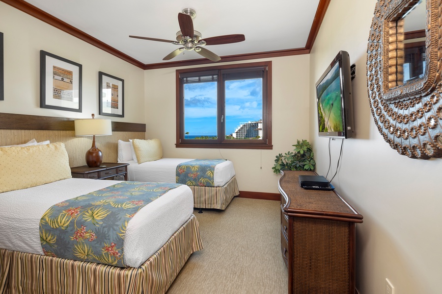The second guest suite is decorated with bright tropical patterns and framed island-inspired art for a true Hawaii experience.